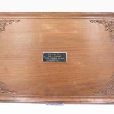 Footed carved wooden tray from the India-Pakistan School.: Image of the footed carved wooden tray with silver plaque. The plaque is engraved with "PRESENTED TO MRS. L.T. JORDAN INDIA-PAKISTAN JUNE 1957."
