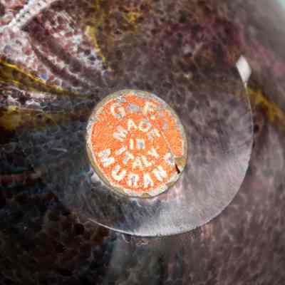 Sticker on ashtray: An orange sticker, "G.F. Made in Italy. Murano."