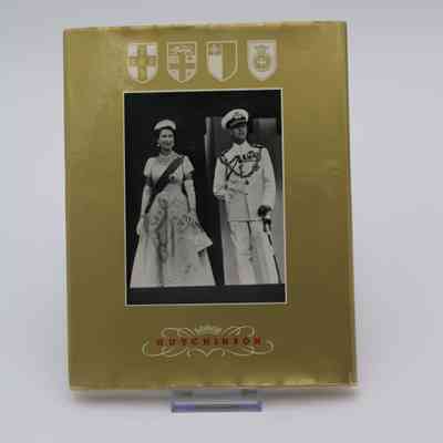 Back cover of "Royal Tour 1953-4": The back cover is gold with a black and white photo of Queen Elizabeth II standing next to King-Consort Philip. Above the photo are the coat of arms for Jamaica, Fiji, Tonga, and Ceylon.