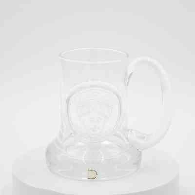 Dartington Glass commemorative tankard.: Image of the glass tankard pressed with King Edgar's head. There is a small sticker on the bottom that says "DARTINGTON ENGLAND."