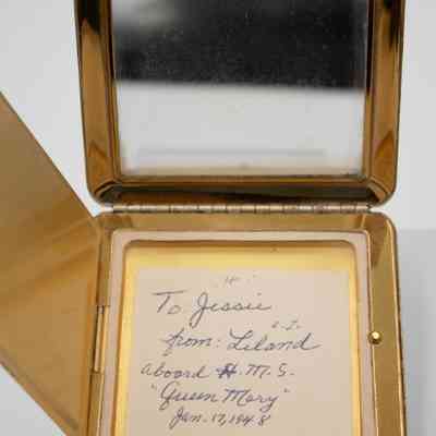 Note from Leland to Jessie: The compact mirror has a personal handwritten note inside, addressed to "Jessie" from "Leland," he writes "aboard the Queen Mary" ship, dated January 17, 1948.