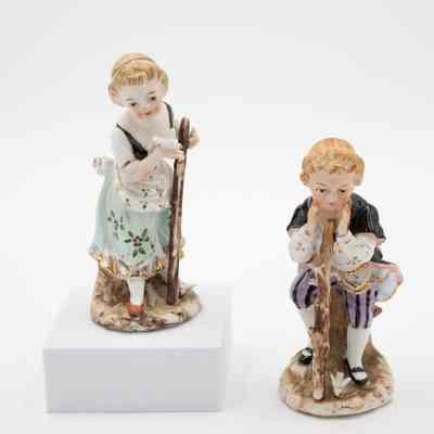 Pair of Painted Porcelain Figurines of Children with Walking Sticks