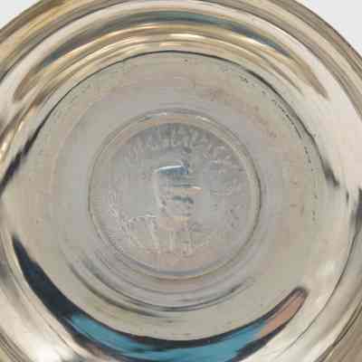 Small silver coin bowl with the a coin of Shah Reza Pahlavi. Pahlavi was the Shah of Persia from 1925-1941.: Up close image of the coin inside the silver coin bowl depicting Shah Reza Pahlavi of Persia.