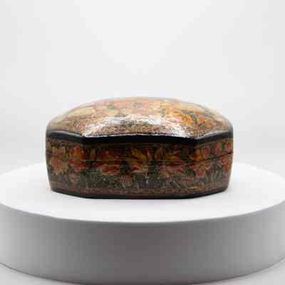 Side of paper mache flower box: The image displays a decorative paper mache box adorned with colorful floral patterns.