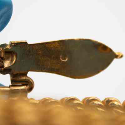 Back of one of the snake heads.: Up close image of the back of one of the snake heads on the bracelet. There is small imprinted "C."