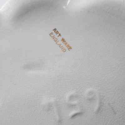 Bottom of porcelain amphora-style vase that belonged to Mrs. Jessie Jordan's mother.: Up close image of the bottom of the porcelain vase. It is stamped in gold, "ART WARE ENGLAND." There is also a number on the bottom, "651."