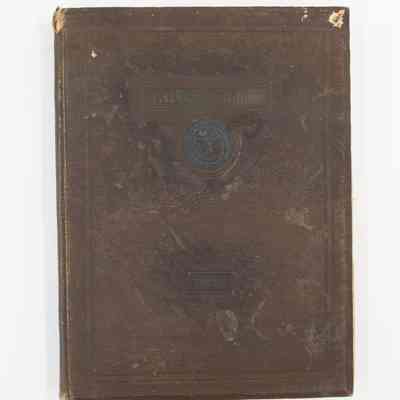 1928 yearbook: The image shows a vintage 1929 Texas A&M University Longhorn Yearbook, featuring a worn brown cover with an embossed Texas A&M seal.