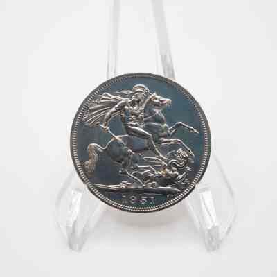 Back of Back of George VI five shilling coin: The back of the George VI five shilling coin features a detailed engraving of St. George slaying a dragon, with the year 1951 inscribed below.