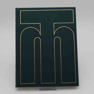 Cover of "The Building of Trans Mountain": The solid green cover with a large, gold, overlapping "T" and "M" logo.