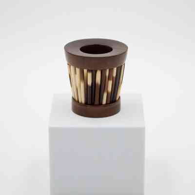 Olive wood matchbox inlaid with porcupine quills.: Image of the olive wood matchbox inlaid with porcupine quills around the base.