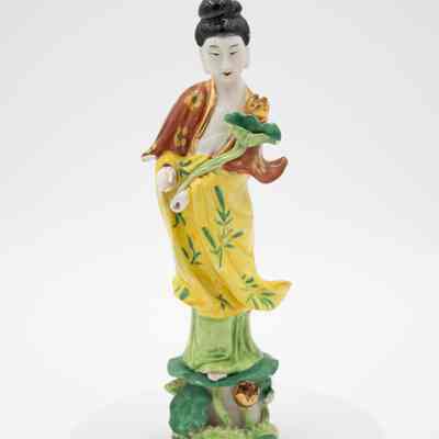 Painted Porcelain Guanyin Figurine in a Yellow Dress and Holding a Flower