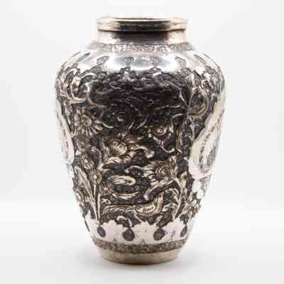 Medium silver urn: The medium-sized Persian repousse silver urn features intricate floral and bird designs in high relief.