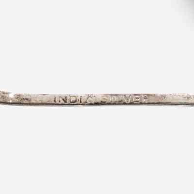 Back of one of the coffee spoons.: Up close image of the stamp on the back of one of the silver coffee spoons. The stamp reads "INDIA SILVER."