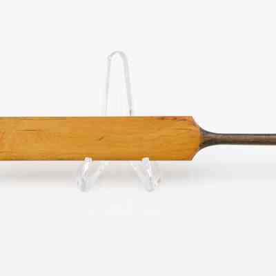 Mini cricket bat: A miniature wooden cricket bat.