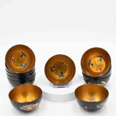 Set of Oriental soup bowls from China.: Image of the set of 12 soups bowls decorated with a black exterior painted with a dragon and a gold interior painted with colorful goldfish.