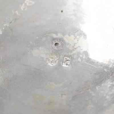 Markings engraved into bottom of bowl: The bottom of the silver bowl has an item number and two small engraved logos.