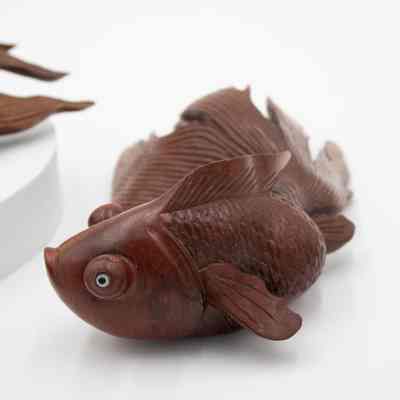 One of the carved red wood goldfish.: Image of one of two carved red wood goldfish.