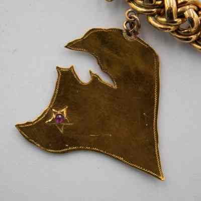 Charm of Kuwait on the bracelet given to Mrs. Jessie Jordan by His Highness Sheikh Ahmad Al Jaber Al Sabah.: Up close image of the charm of Kuwait. The charm shows the location of Ahmadi, denoted by a small ruby and star.