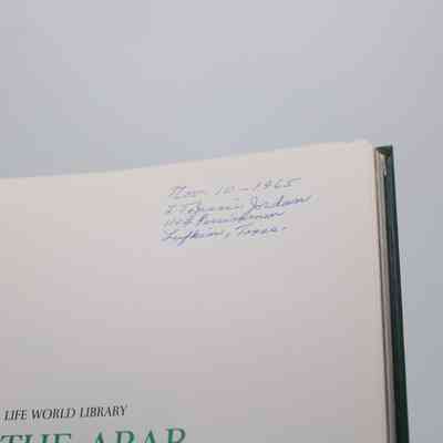 Inside Signature: Inside "The Arab World” is a signature in blue ink. It reads "Nov. 10 - 1965 L.T. Jessie Jordan 1104 Persimmon Lufkin, Texas"