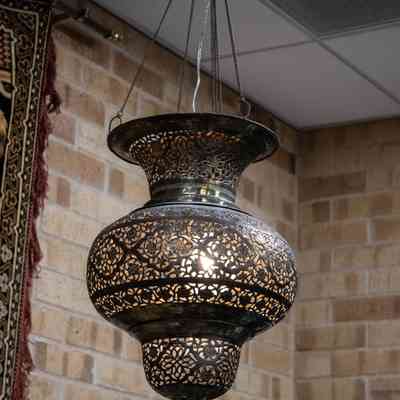 Hanging lantern: The ornate brass hanging lantern beautifully features an intricate floral design pattern.
