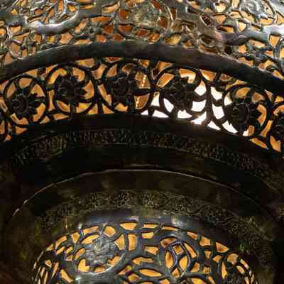 Hanging lantern: The brass hanging lanterns feature intricate flower designs, casting warm light through patterns.