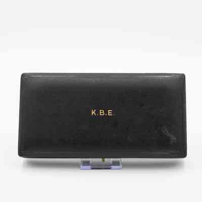 Outside of box: A black leather box with "K.B.E." in gold text.