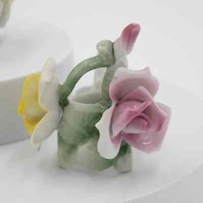 Rose candleholders: Two painted ceramic rose candleholders, featuring delicate pastel flowers in pink, yellow, and blue.