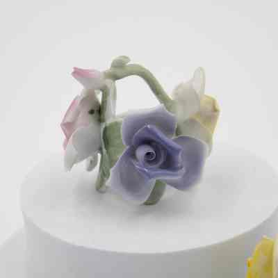 Rose candleholders: Two painted ceramic rose candleholders, featuring delicate pastel flowers in pink, yellow, and blue.