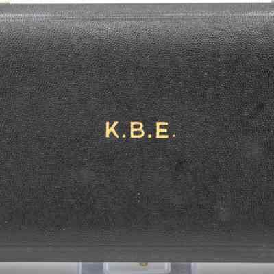 Outside of box: A black leather box with "K.B.E." in gold text.