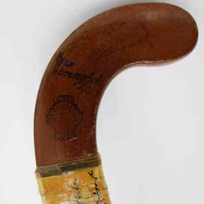 Toe of field hockey stick: The field hockey stick has a wooden toe with the word "Springbok."