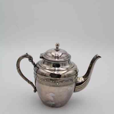 Silver tea pot: A polished silver teapot with ornate detailing stands elegantly.