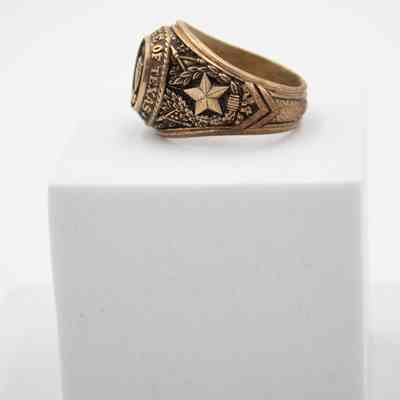 Side of L.T. Jordan's 1929 class ring from Texas A&M University.: Image of the left side of L.T.'s class ring from Texas A&M. It shows the five-point star of Texas with an olive branch and Live Oak branch around it.
