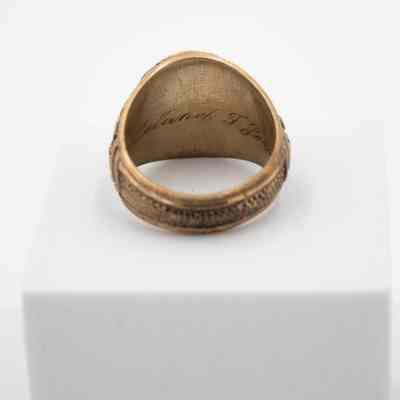 Inside of L.T. Jordan's 1929 class ring from Texas A&M University.: Up close image of the inside of L.T.'s class ring. It is engraved with his name. "Leland T. Jordan" in cursive.