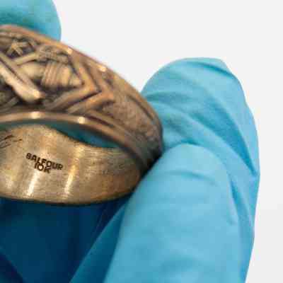 Inside of L.T. Jordan's 1929 class ring from Texas A&M University.: Up close image of the inside of L.T.'s class ring. It is debossed with the company name, "BALFOUR," and "10K," denoting the gold type.