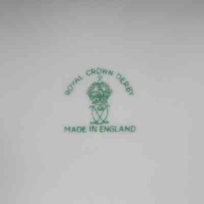 Bottom of the Royal Crown Derby rectangular cigarette box.: Up close image of the bottom of the rectangular cigarette box. There is a green stamped maker's mark that reads "ROYAL CROWN DERBY MADE IN ENGLAND" with a crown in the middle.