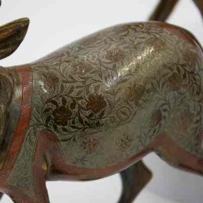 Etchings on reindeers back: The reindeer have flowers and leaved etched into their torsos, with orange enameled stripes surrounding its etchings.