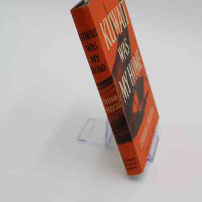 Spine of "Kuwait Was My Home": The image from the front of the book continues onto the spine with the title written horizontally.