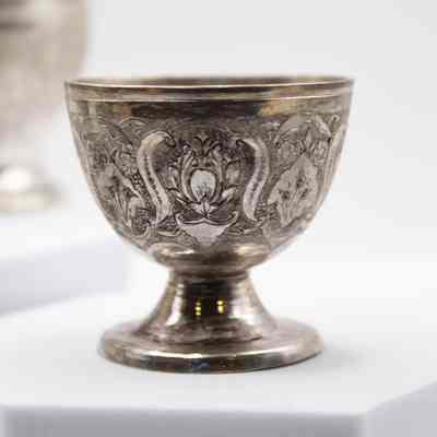 Silver goblet cup: A small Persian silver goblet features intricate leaf engravings.
