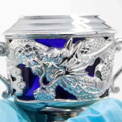 Silver and blue cobalt glass lighter from Persia.: Up close image of the silver and blue cobalt glass lighter decorated with a dragon.