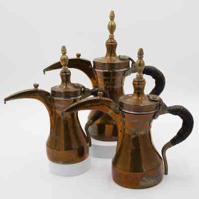 Set of Copper and Brass Coffee Pots with Leather Woven Handles and Stamped Arabic Script