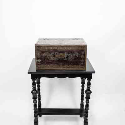 Front view of desk and table: A portable folding wooden desk from Venezuela sits on a decorative ebony table.