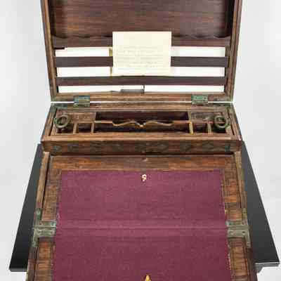 Inside of desk: The folding wooden desk from Venezuela is made of ebony, featuring compartments and a purple felt writing surface.