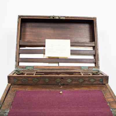 Inside of desk: The Venezuelan folding writing desk features elegant ebony craftsmanship and velvet-lined compartments.
