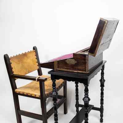 Desk, table and chair: An ebony folding desk from Venezuela pairs with a vintage leather chair beside it.