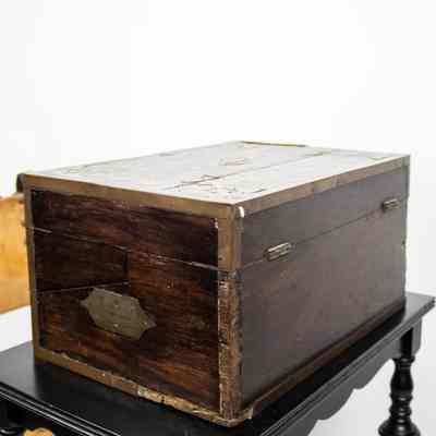 Closed back view: The image shows a portable, folding wooden desk from Venezuela, crafted from rich ebony wood.