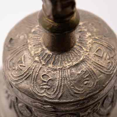 Bell: The image shows the detailed engravings on a brass Tibetan ritual prayer bell.