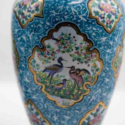 Vase with birds: The blue enameled vase features intricate images of birds and decorative floral motifs.