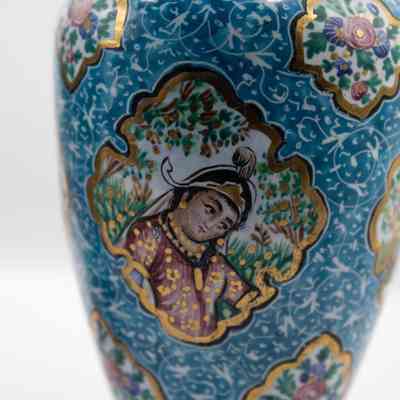 Vase with woman: The small blue enameled vase features intricate decorations of people and birds against a richly detailed background.