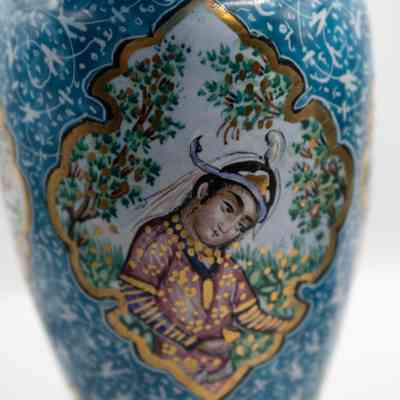 Vase with woman: A small blue enameled vase features intricate designs, including people and birds, elegantly depicted.