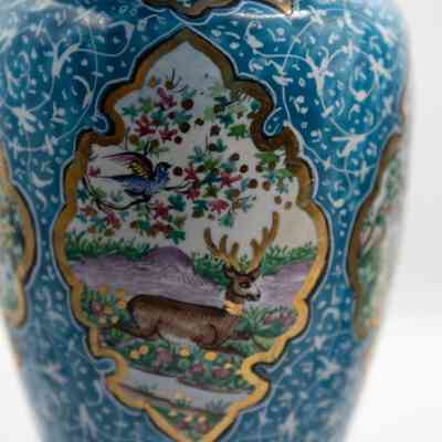 Vase with bird and deer: The blue enameled vase features intricate paintings of birds and floral designs.